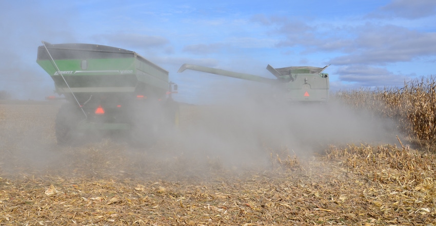 combine and cart in cornfield during harvest