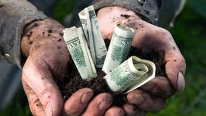 Farmer hands holding money and dirt