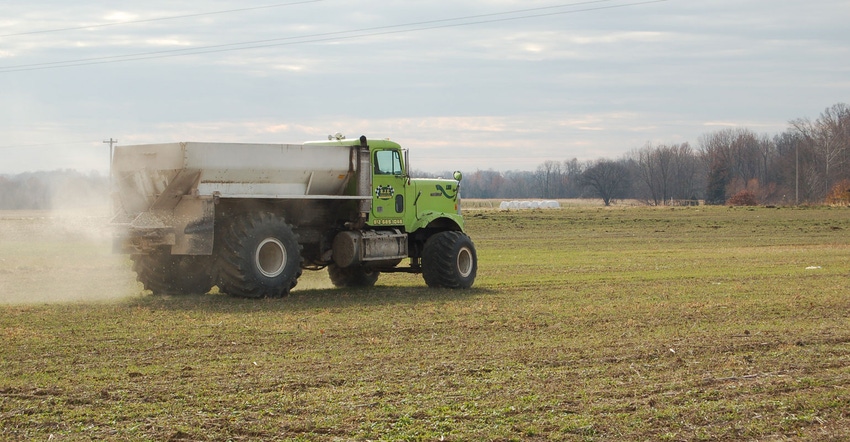 truck applying fertilizer to field