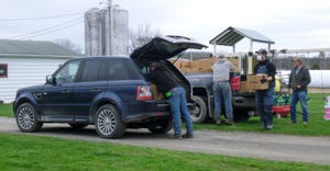 Volunteers load dairy products into a truck at Taylor Pride Farms in Lawrenceville, Pa.