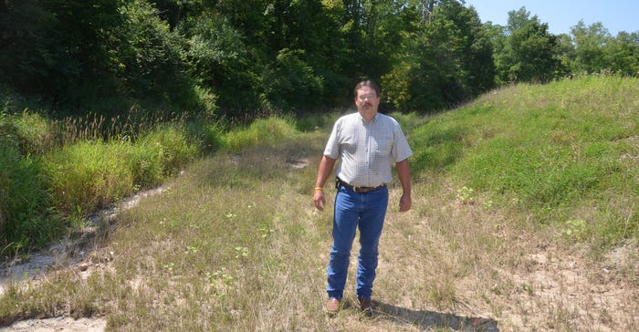 Jamie Bultemeier stands on the bench of the two-stage ditch Jamie Bultemeier stands on the bench of the two-stage ditch