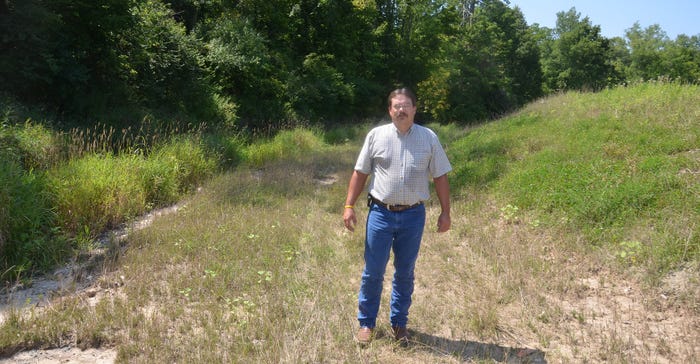 Jamie Bultemeier stands on the bench of the two-stage ditch 