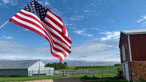 American flag flying over farmyard