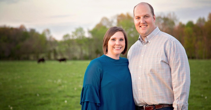 Drs. Josh and Sarah Ison pose for a photo in an open field