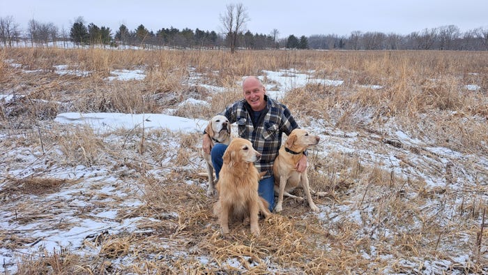 Al Martens of Waupun, Wis., in snowy field with his three dogs Al Martens of Waupun, Wis., in snowy field with his three dogs