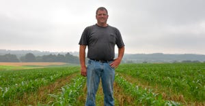 Ben Peckman stands in his field of 60-inch corn and cover crops