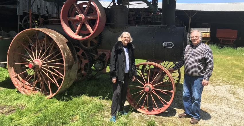 Jim and Carol Jo Droege stand in front of Keck Gonnerman steam engine