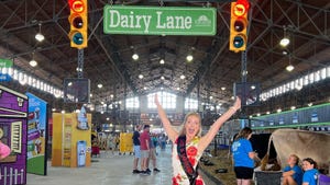 Ashley Hagenow inside convention center under sign that says Dairy Lane