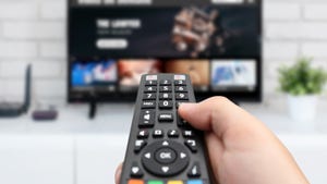 hand pointing remote at TV