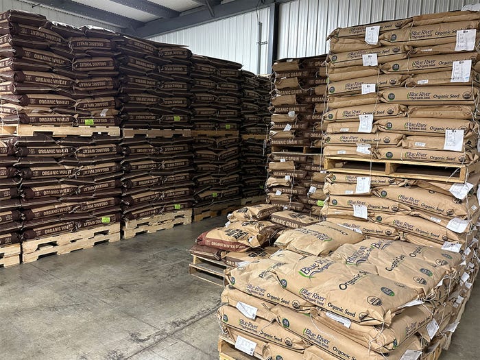 Bags of seed stacked in warehouse