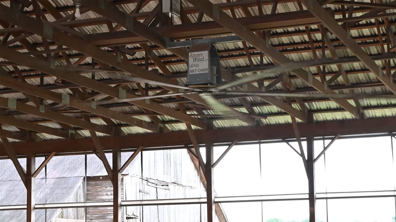 Fans installed in wooden beams of barn