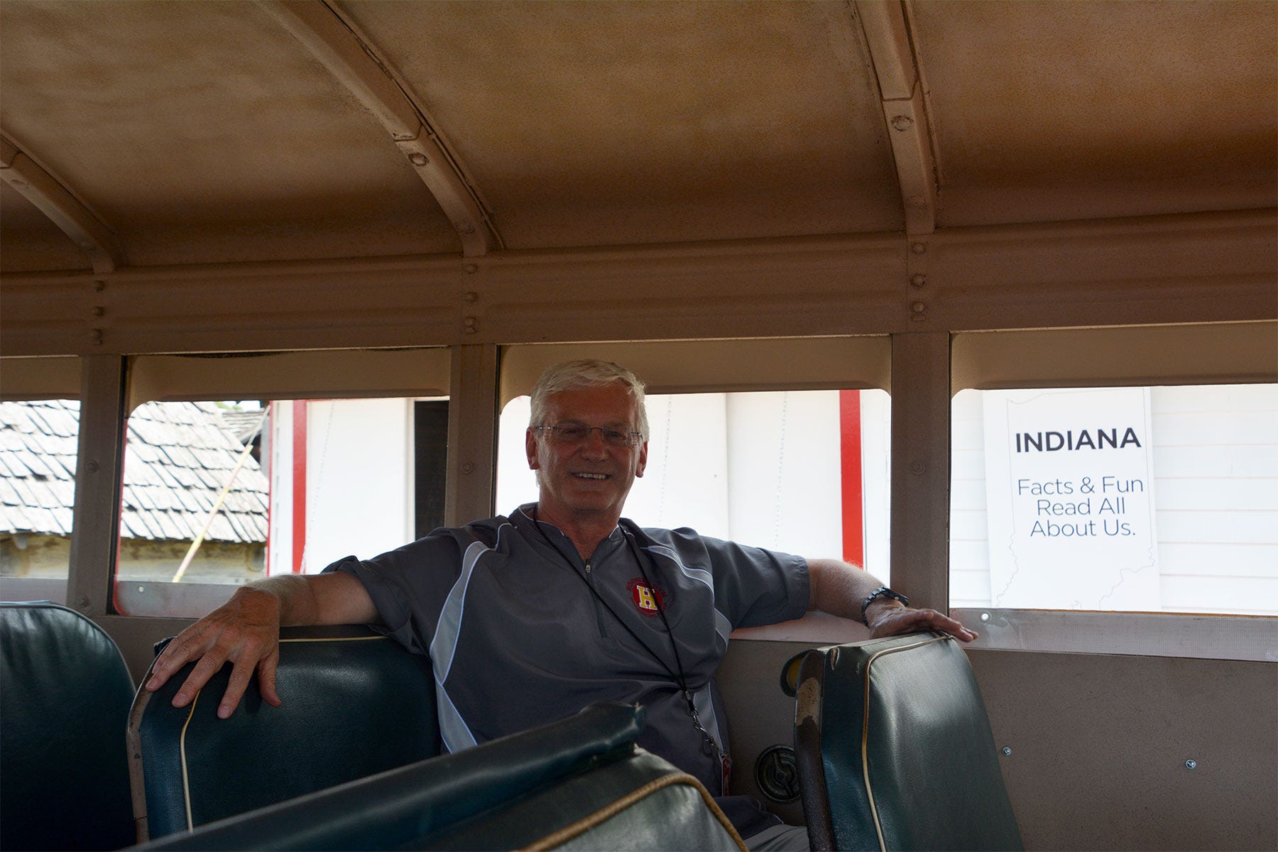 man sitting inside an old school bus
