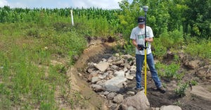 Conservation Corps apprentice checks on erosion