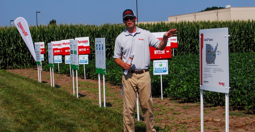 A representative speaks about a yield trial with corn hybrid and soybeans varieties