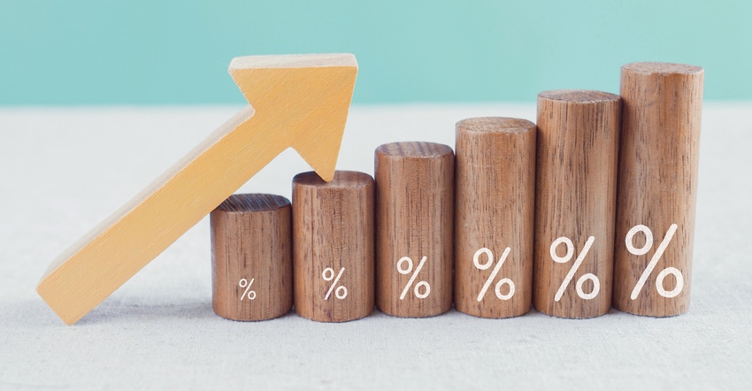 Wooden blocks with percentage sign and arrow up, interest rate concept