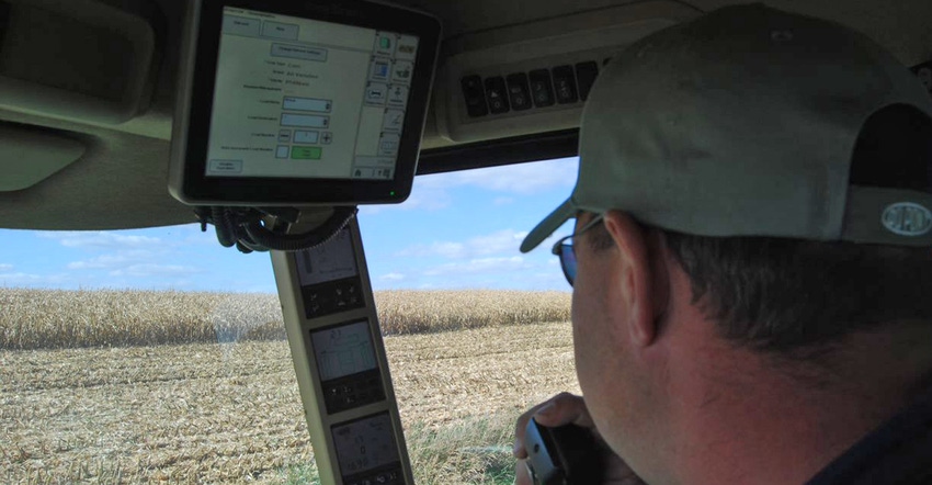 farmer inside cab of tractor with GPS 