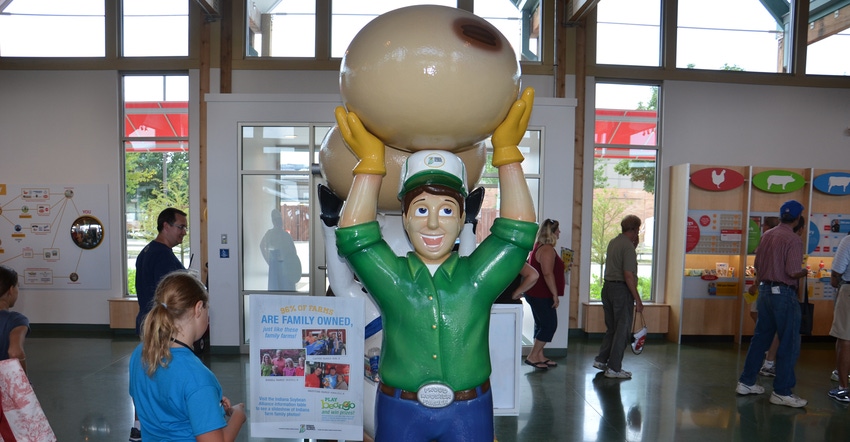 Statue of a farmer holding a huge soybean in the Glass Barn at the Indiana State Fair