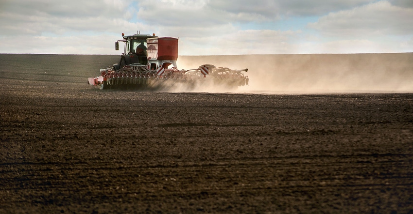 Tractor fertilizing field Tractor fertilizing field
