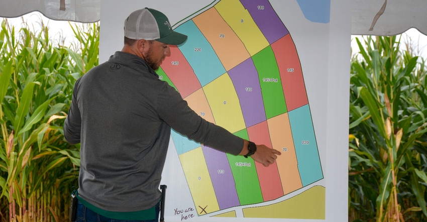 Tim Hushon, agronomist at The Mill, points to a diagram of test plots 
