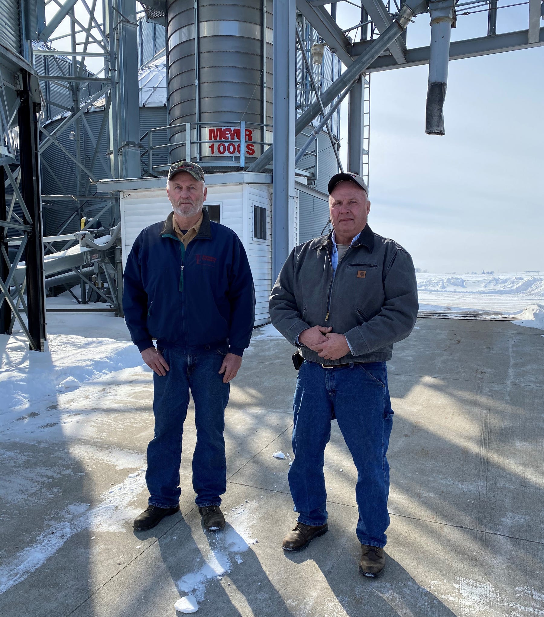 Doug and Don Midthun, Arlington, Wis., stand in front of their grain center