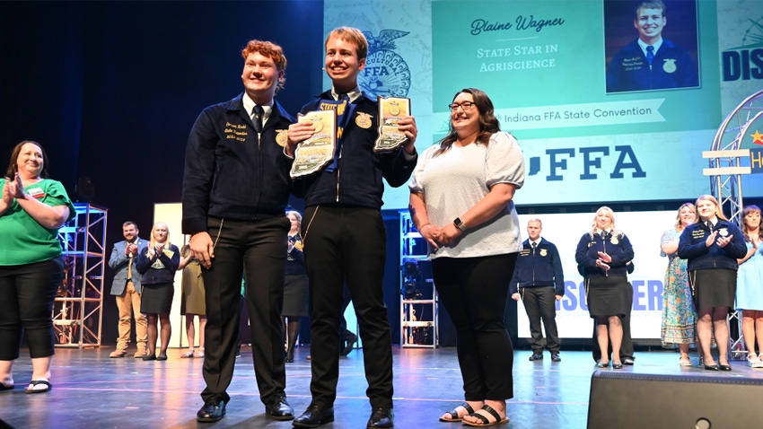 Indiana FFA officer Carson Rudd (left) presents the Star in Agriscience award to Blaine Wagner