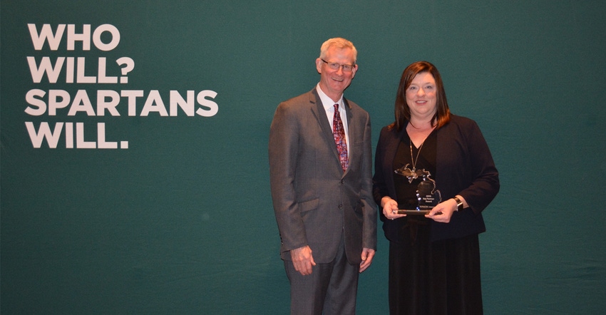 Apple Committee Executive Director Diane Smith receives the MSU Extension Key Partner Award from Ron Hendrick