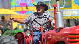 Farmer riding a Massey-Harris tractor