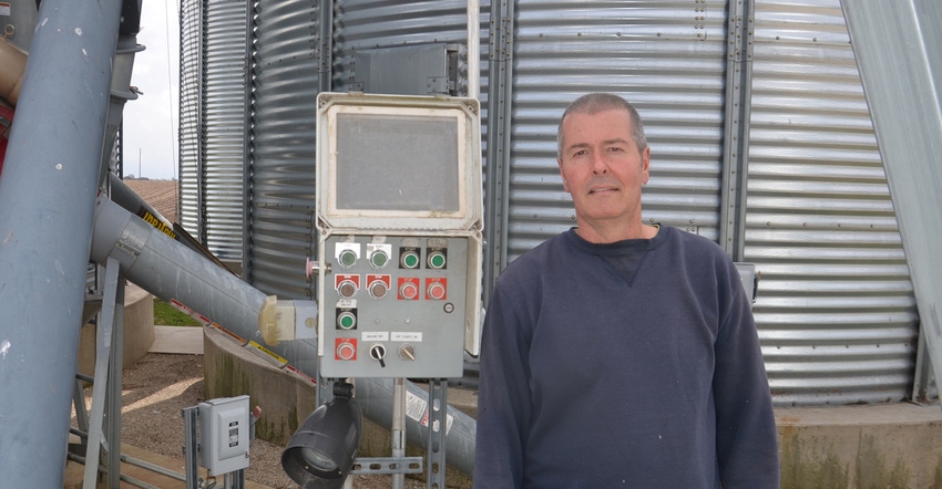 Dan Coapstick standing in front of his grain system
