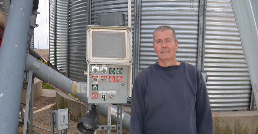 Dan Coapstick standing in front of his grain system Dan Coapstick standing in front of his grain system