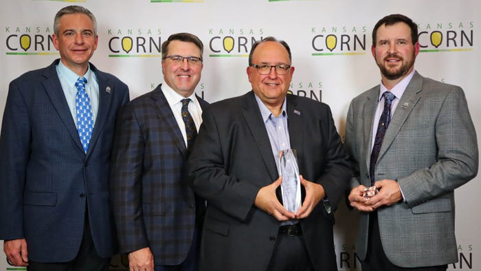 Greg Krissek, Manhattan, Kan., center, was honored with the 2024 Kansas Corn Impact Award for his career serving Kansas corn farmers