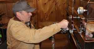 Andrew Chisholm working on bottling maple syrup