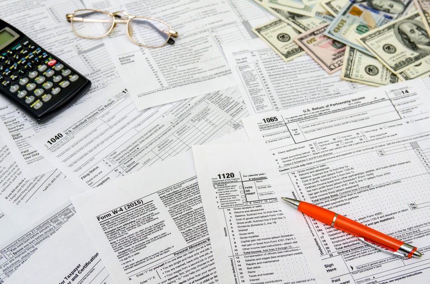 calculating-income-tax-return-with-money-and-ThinkstockPhotos-495226396.jpg