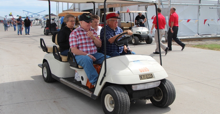 Husker Harvest Days visitors in a golf cart