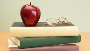 Textbooks with apple and glasses
