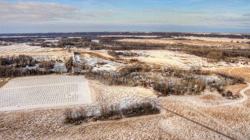  An aerial view of farmland covered by a dusting of snow