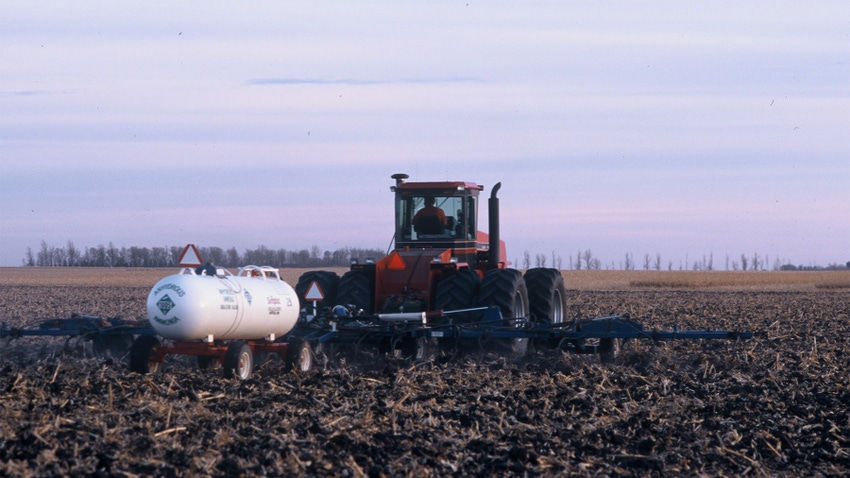 Tractor applying nitrification inhibitor to a field