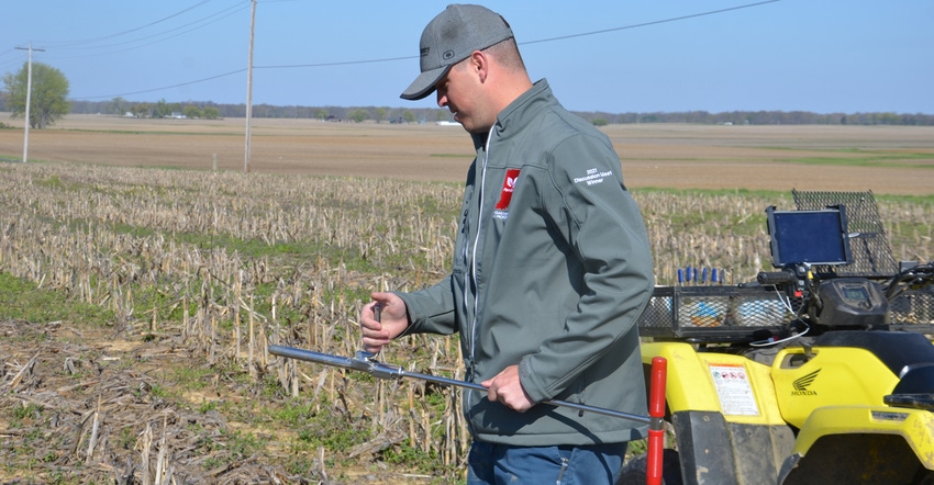 Nathan Bush inspecting soil sample Nathan Bush inspecting soil sample