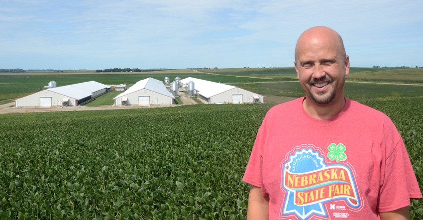 Scott Wagner stands on a hill overlooking his four pullet barns and one rooster barn near Hooper, Neb