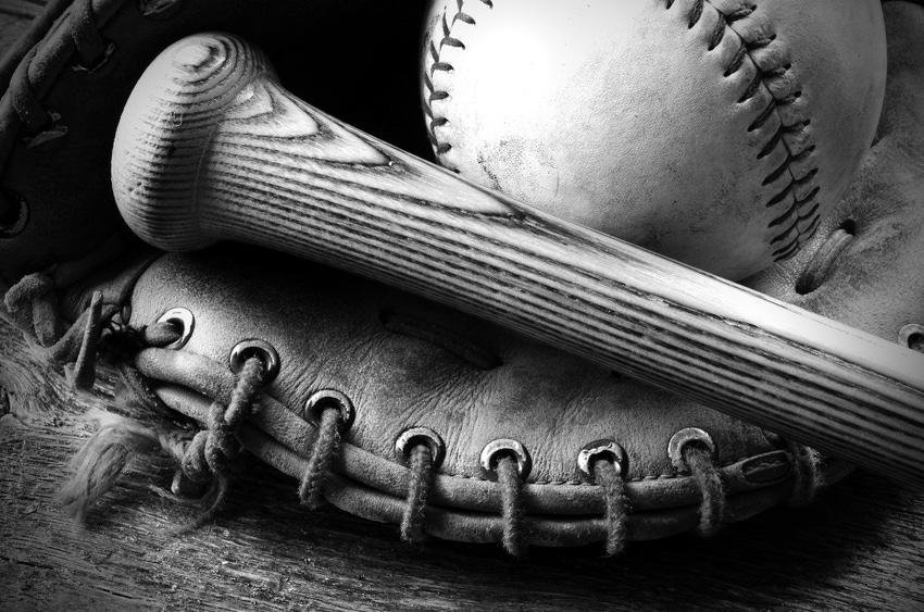 old baseball, glove and bat.A black and white image of an old baseball glove and bat.