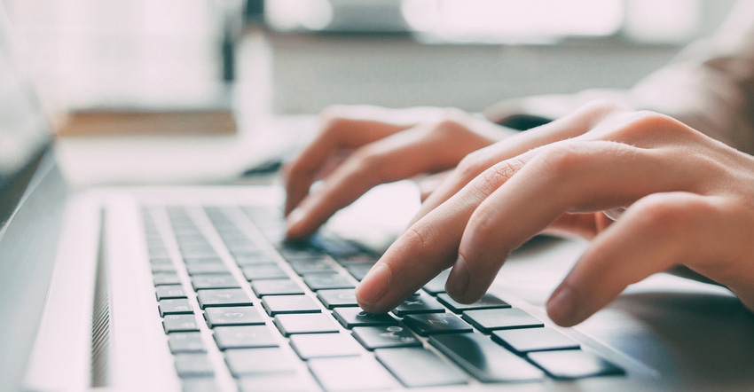 hands typing on keyboard