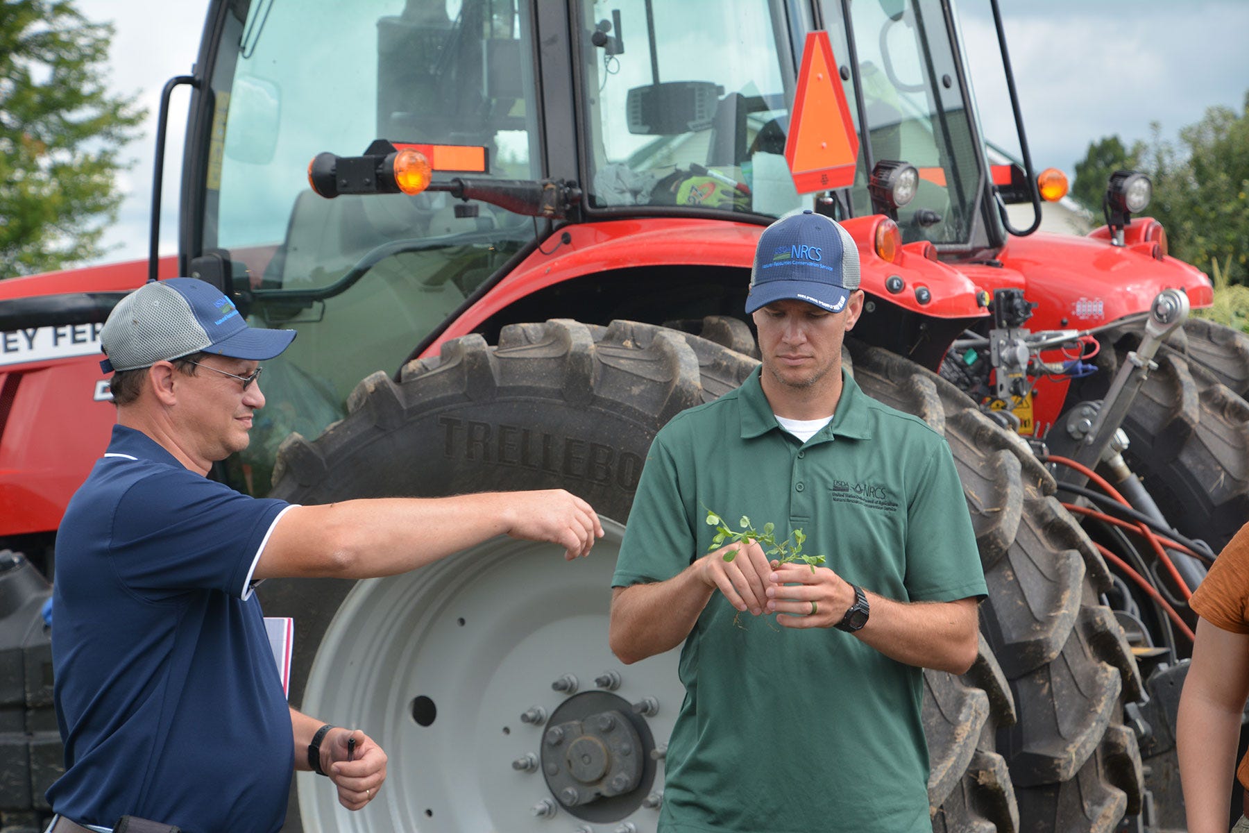 two NRCS specialists look at soil samples