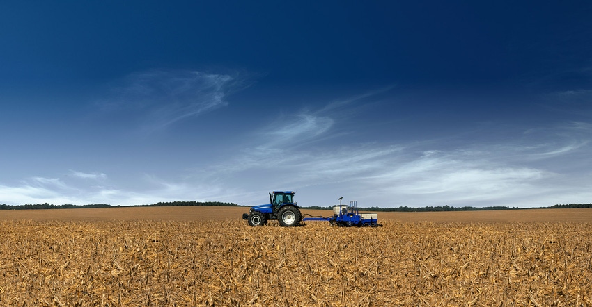 planting soybeans with blue tractor