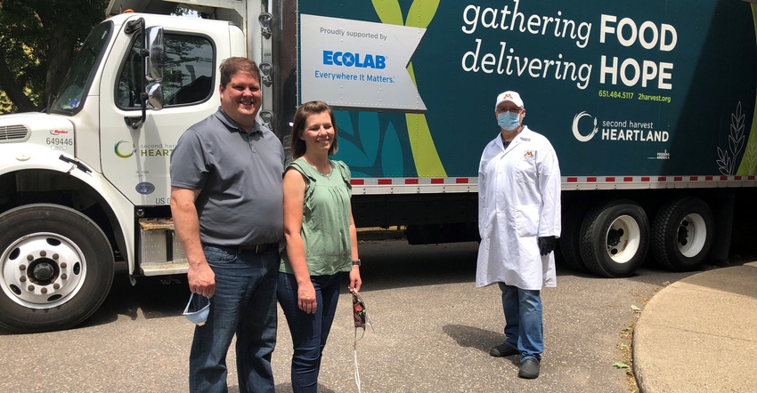 Minnesota pig farmers Mike and Rebekah Patterson, Kenyon, Minn., with  Ryan Cox as they dropped off a load of pigs to be proc