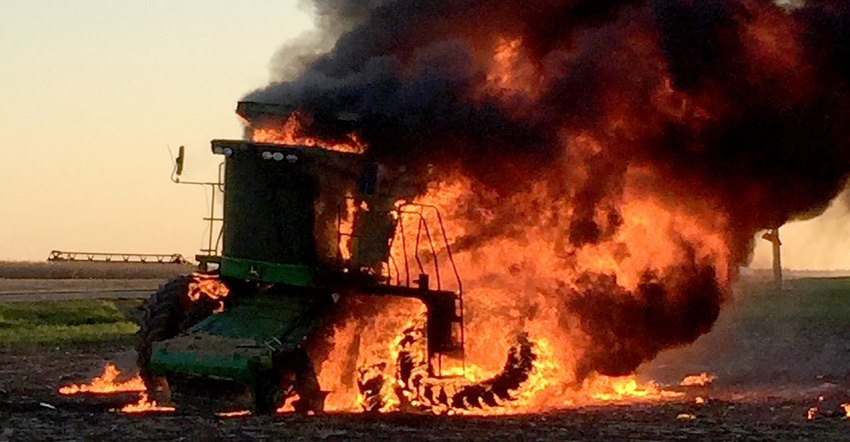 combine on fire and consumed by flames in field