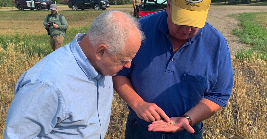Gov. Tim Walz talked with farmer Jim Reitmeier on his Crookston, Minn., farm