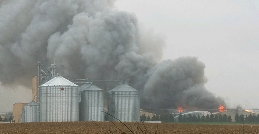 barn on fire with plumes of smoke
