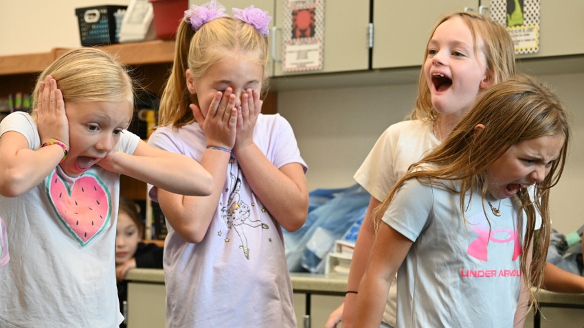 Four excited girls in classroom Four excited girls in classroom