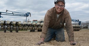Indiana farmer Chris Mann digs for seed.