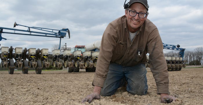 Indiana farmer Chris Mann digs for seed. Indiana farmer Chris Mann digs for seed.