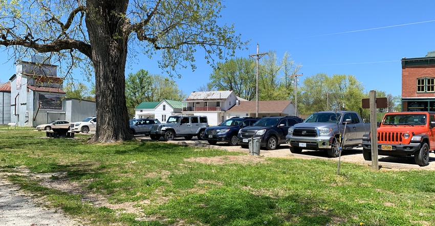 Row of cars with bike racks fill the small town of Treloar, Missouri